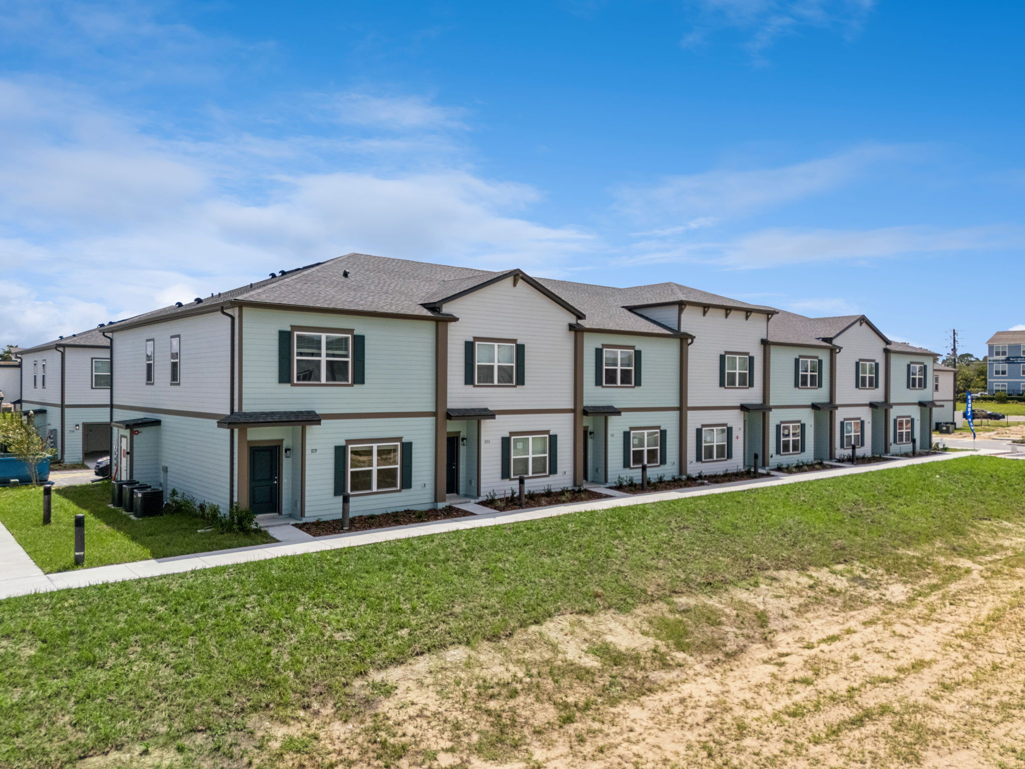 Completed townhome buildings shown before playing the overview film